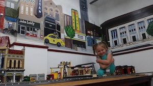 Tiffany's daughter helps with the Lego setup.